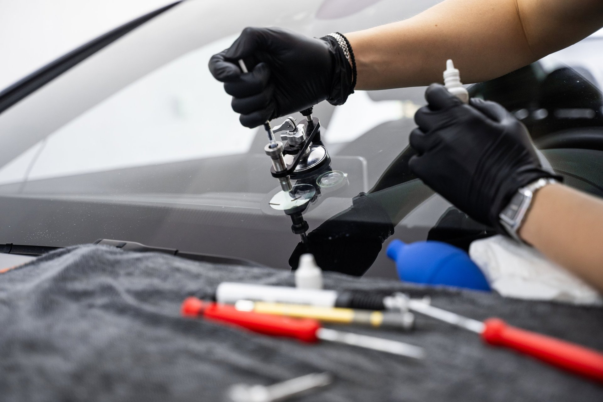 Professional technician repairing windscreen with precision